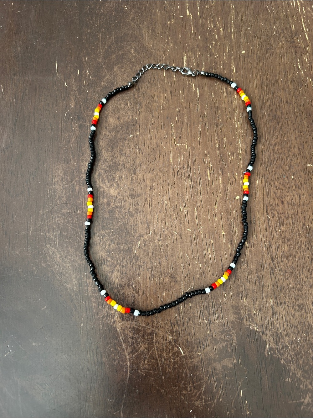 Handmade Black Seed Bead Necklace with Red, Yellow & White Accents